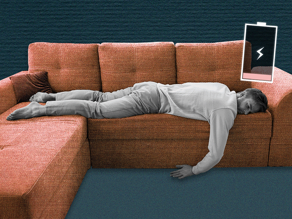 a man lying facedown on the couch because he is recovering from burnout