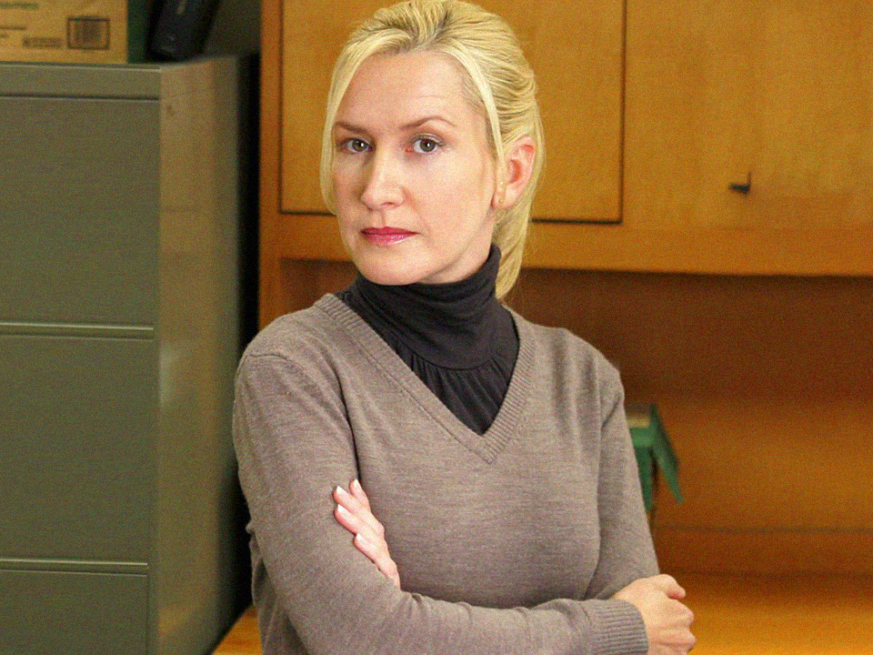 Angela from The Office standing with her arms crossed because she is passive aggressive