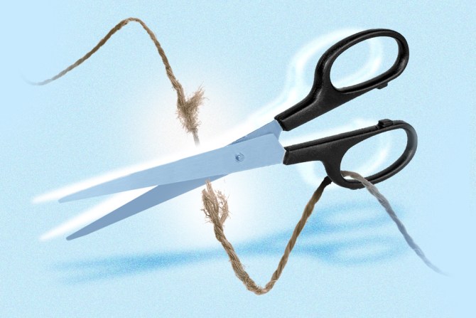 scissors cutting a string to represent how to break up with someone