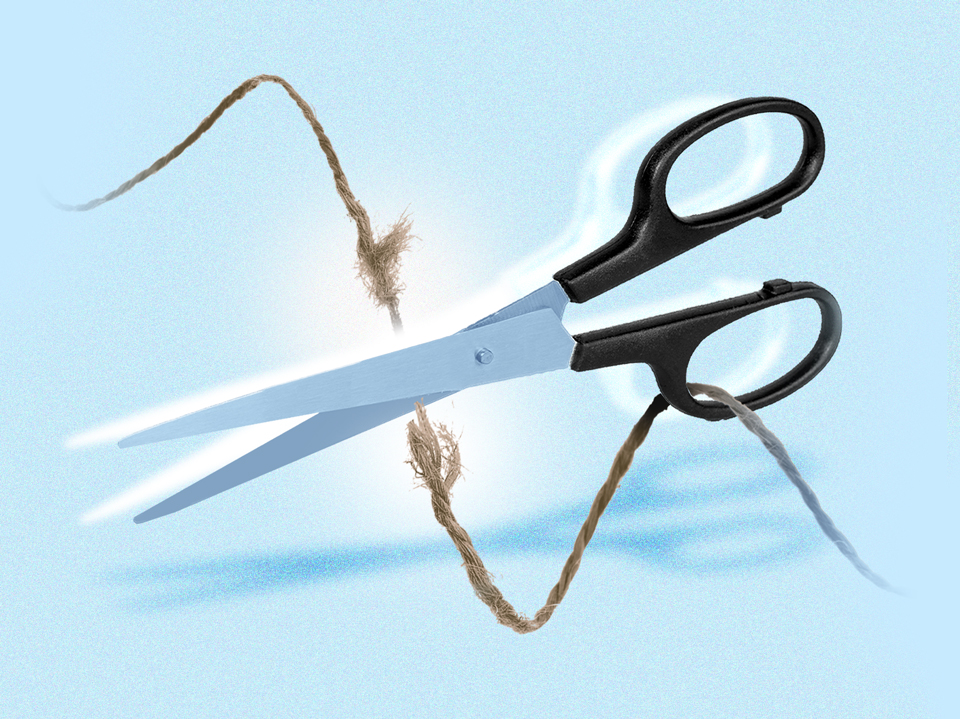 scissors cutting a string to represent how to break up with someone