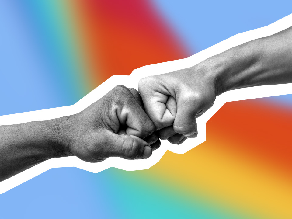 two fists bumping each other on a blue, green, yellow, and red background