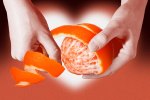 orange peel theory going viral on TikTok represented by hands peeling an orange