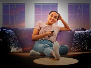 a woman watching tv to cope with stress