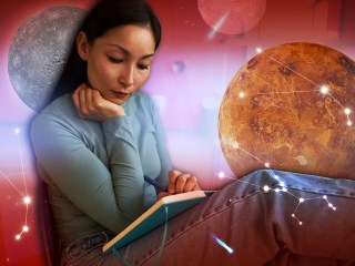A woman reading with planets in the background
